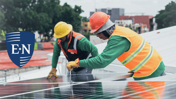 Two men installing solar panels for a company that provides small employee benefits. 