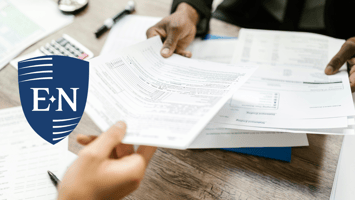 Two people reviewing personal idemnity insurance documents.