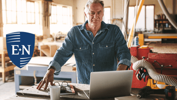 business owner looking at laptop