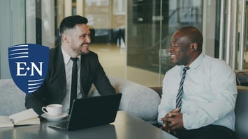 Two business owners discussing managing risk for business in their office,
