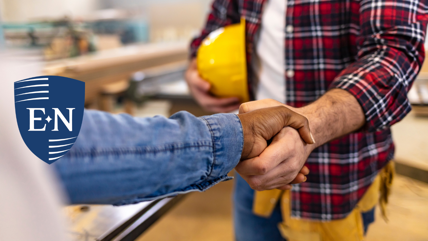 Shaking hands after discussing subcontractor default insurance. 